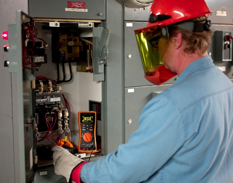 technician-troubleshooting-electrical-distribution-board-with-handheld-multimeter